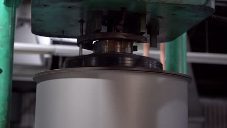 Each-drum-can-is-fitted-with-a-motorized-machining-tool-to-ensure-its-precise-size