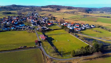 Erhöhter-Blick-Auf-Ein-Lebendiges-Dorf,-Umgeben-Von-üppigen-Weiden