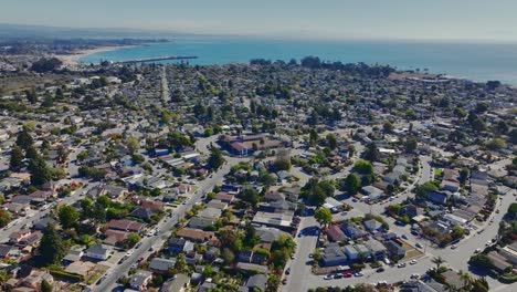 Aerial-footage-of-Westside-Santa-Cruz's-'Circles'-neighborhood-on-a-sunny-day,-backdrop-of-Monterey-Bay