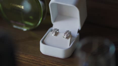 Pair-of-luxurious-diamond-earrings-in-a-white-box