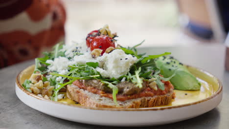 Gourmet-toast-with-fresh-arugula-and-cheese-on-plate