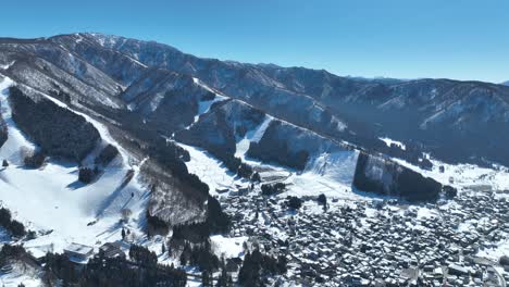 Aerial-establishing-shot-of-Japans-Nozawaonsen-Mountain-Ski-Resort-Village