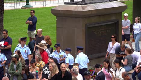 Crowds-of-people-gather-in-downtown-Brisbane-city,-swelling-with-anticipation-before-the-commencement-of-the-annual-tradition-Anzac-Day-parade-at-Anzac-Square,-close-up-shot