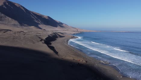 Arid-sandy-landscape-as-desert-mountains-meet-ocean-coast-in-Chile