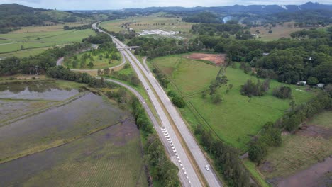 Vehículos-Que-Navegan-Por-La-Autopista-Del-Pacífico-A-Través-De-Campos-En-Tanglewood,-Nueva-Gales-Del-Sur,-Australia