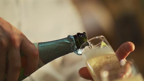 A-man-celebrates-by-pouring-himself-a-glass-of-bubbly-champagne