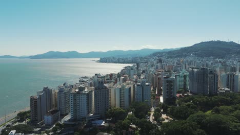 Florianopolis-downtown,-it-captures-the-beauty-of-its-architectural-landmarks-against-the-backdrop-of-the-picturesque-sea-and-sunlit-mountains-on-a-sunny-day