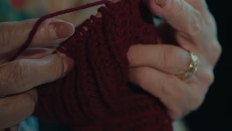 close-up-of-senior-female-old-skilled-hands-working-on-crochet