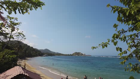 Slow-revealing-shot-of-tourists-at-the-beaches-within-Tayrona-National-Park