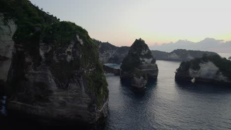 Volando-A-Través-De-Acantilados-De-Piedra-Caliza-Hacia-Diamond-Beach-Al-Atardecer-En-Nusa-Penida,-Bali,-Indonesia