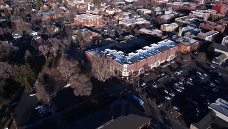 Aerial-View-of-Downtown-Flagstaff-AZ-US-on-Sunny-Winter-Day,-Street-Traffic-and-Buildings