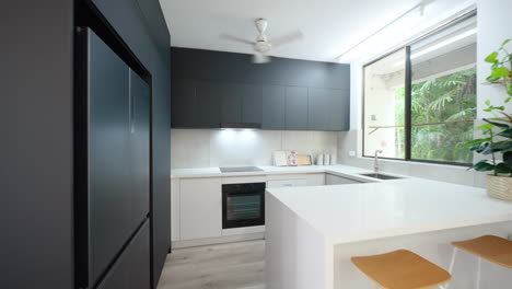 Simplistic-Modern-luxury-kitchen-with-black-cabinetry-and-white-countertops