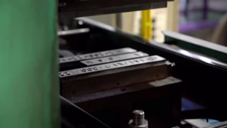 A-metal-stamping-machine-presses-identification-numbers-into-the-drum-lids