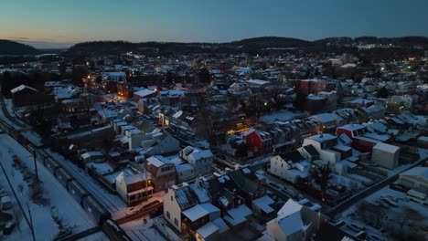 Train-on-track-in-small-american-town-during-winter-snow