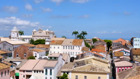 Aerial-view-of-the-houses-in-the-Pelourinho-neigbourhood-and-the-sea-at-background,-Salvador,-Bahia,-Brazil