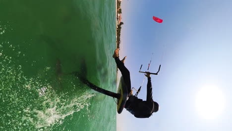 Sitting-Down-While-Foiling-On-A-Hydrofoil-Kite-Surfing-Board