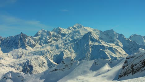 Summit-Of-Mont-Blanc-Covered-In-Snow-Against-Blue-Sky-In-France