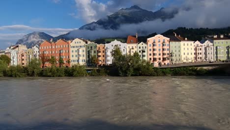 Urban-City-Scape---River-flowing-with-Apartment-Buildings-in-Far-Background