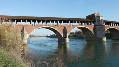 Panorama-of-Ponte-Coperto-bridge-is-over-the-Ticino-river-in-Pavia-at-sunny-day