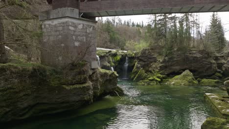 A-slow-cinematic-shot-of-Traunfall-Austria-with-approach-under-the-bridge