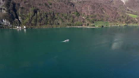 Ferry-Boat-on-idyllic-Walensee-Lake-in-Switzerland-surrounded-by-alps-in-spring-season