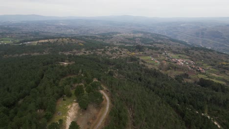 Panoramic-aerial-pan-across-forested-hillside-above-Punxin-Valley-Ourense-Spain