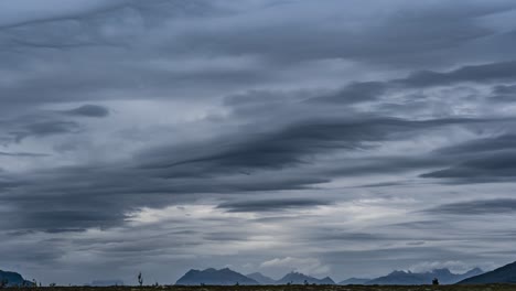 Lenticular-clouds-in-the-dark-stormy-sky-and-carried-fast-by-the-strong-wind