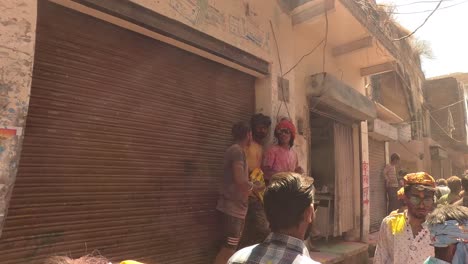 pov-shot-men-are-going-towards-the-temple-with-flying-colors-and-many-people-are-shooting-in-mobiles