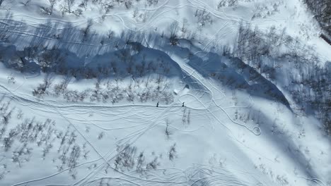 Father-and-Son-Walk-through-thick-snowy-mountain-side