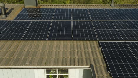 Private-house-rooftop-with-Photovoltaic-cells,-fall-evening---Aerial-view