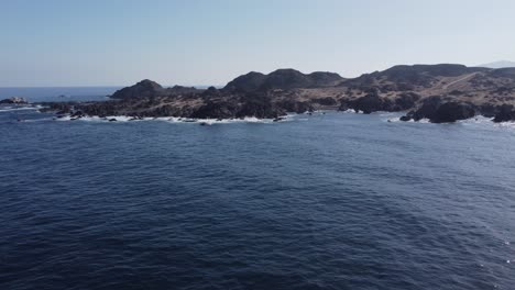 Ocean-aerial-rotates-to-rocky-desert-coastline-of-rugged-central-Chile