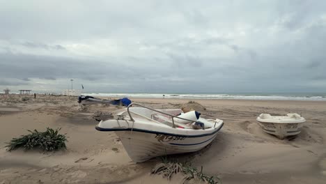 Time-lapse-video-showcasing-the-coastline-and-small-boats-on-a-sandy-beach-along-the-Spanish-coast,-embodying-the-idea-of-travel-and-vacation