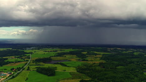 Dark-rain-clouds-begin-to-arrive-over-the-green-countryside-of-Riga,-Latvia
