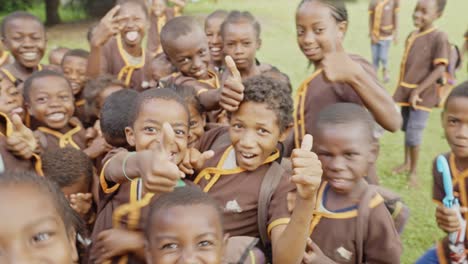 Group-of-happy-african-Malagasy-kids-wearing-school-uniforms-have-fun-in-front-of-amera