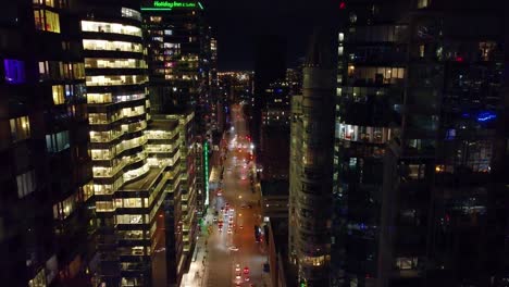 Night-footage-among-the-illuminated-skyscrapers,-downtown-Montreal