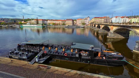 People-transport-boat-Vltava-River-near-Charles-Bridge-Prague-Czech-Republic