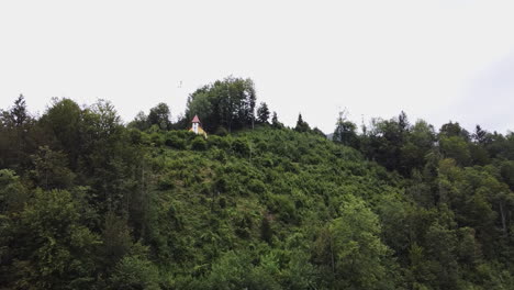 Small-chapel-on-a-hill,-place-of-worship,-drone-flight