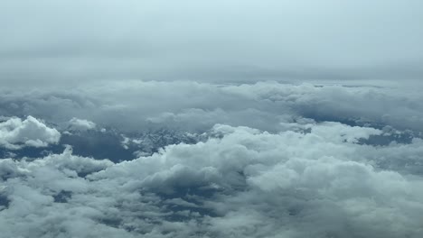 Immersive-Pilot-POV-flying-across-a-snowed-mountainous-landscape-shot-from-a-jet-cabin