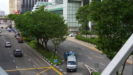 Tilt-up-shot-capturing-street-traffics-on-New-bridge-road-at-Clarke-Quay-Central-shopping-district,-metropolitan-area-of-Singapore