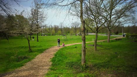 Timelapse-in-Noorderpark-park-Amsterdam-during-spring-with-families-walking-over-path