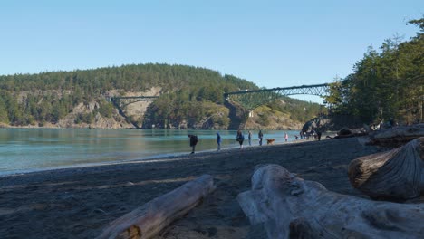 People-walking-on-the-beach-at-Deception-Pass-State-Park-midday