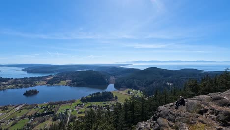 Old-man-sitting-on-Mount-Erie-looking-out-over-Lake-Campbell-in-Washington