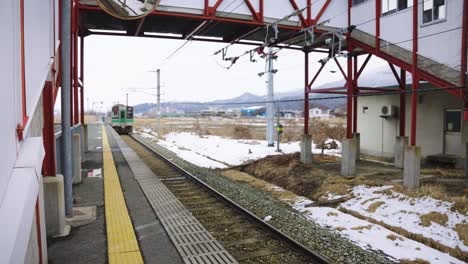 Japanese-Train-Departs-Rural-Station-in-Yamagata-Prefecture,-Tohoku-Region