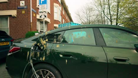 Electric-BMW-i4-car-poluted-and-smeared-with-bird-feces-in-Amsterdam-street