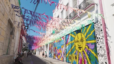 Festive-streamers-adorn-Santa-Marta's-colorful-street-art-scene,-Colombia