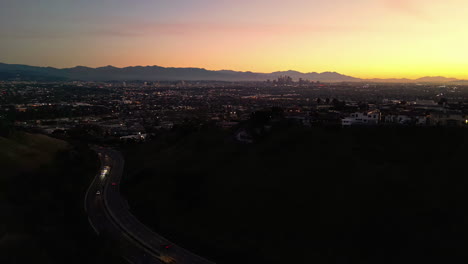 Aerial-panoramic-drone-sunset-at-Los-Angeles-California-keeneth-hahn-Ladera-Heights-recreational-tourist-destination,-mountain-background,-golden-gradient-skyline