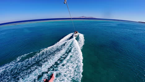 POV-of-parasailing-over-blue-ocean