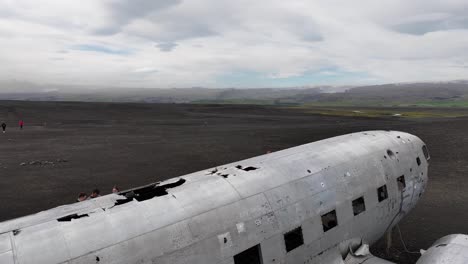 Aerial-View,-Remains-of-US-Navy-Wrecked-Airplane-on-Coastline-of-Iceland,-Tourist-Around-Attraction
