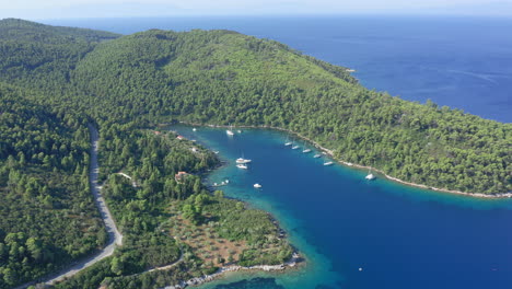 Aerial:-Panoramic-drone-shot-of-beautiful-Panormos-bay-in-Skopelos-island,-Sporades,-Greece