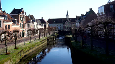 Historisches-Mittelalterliches-Stadtzentrum-Mit-Menschen,-Die-Entlang-Des-Historischen-Land--Und-Wassertors,-Dem-Koppeltor-In-Amersfoort,-Spazieren-Oder-Rad-Fahren